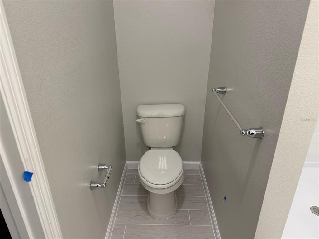 611 Pothos Street Apopka, FL 32703 - Photo 23 of 34 a white toilet sitting in a bathroom