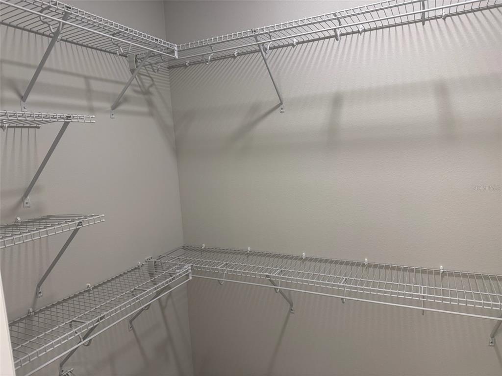 611 Pothos Street Apopka, FL 32703 - Photo 24 of 34 a view of a room with racks on the wall