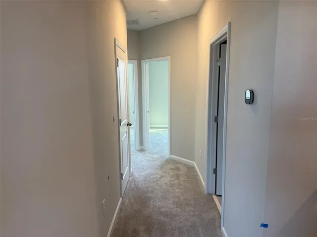 a view of a hallway with a room