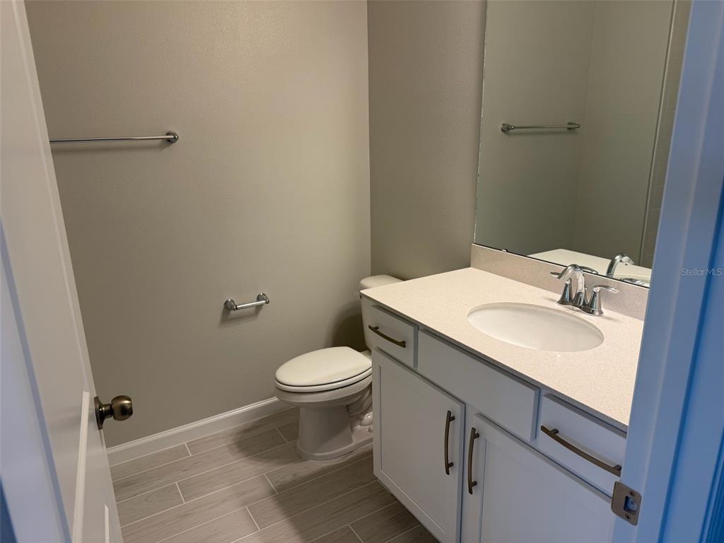 611 Pothos Street Apopka, FL 32703 - Photo 27 of 34 a bathroom with a sink toilet and vanity