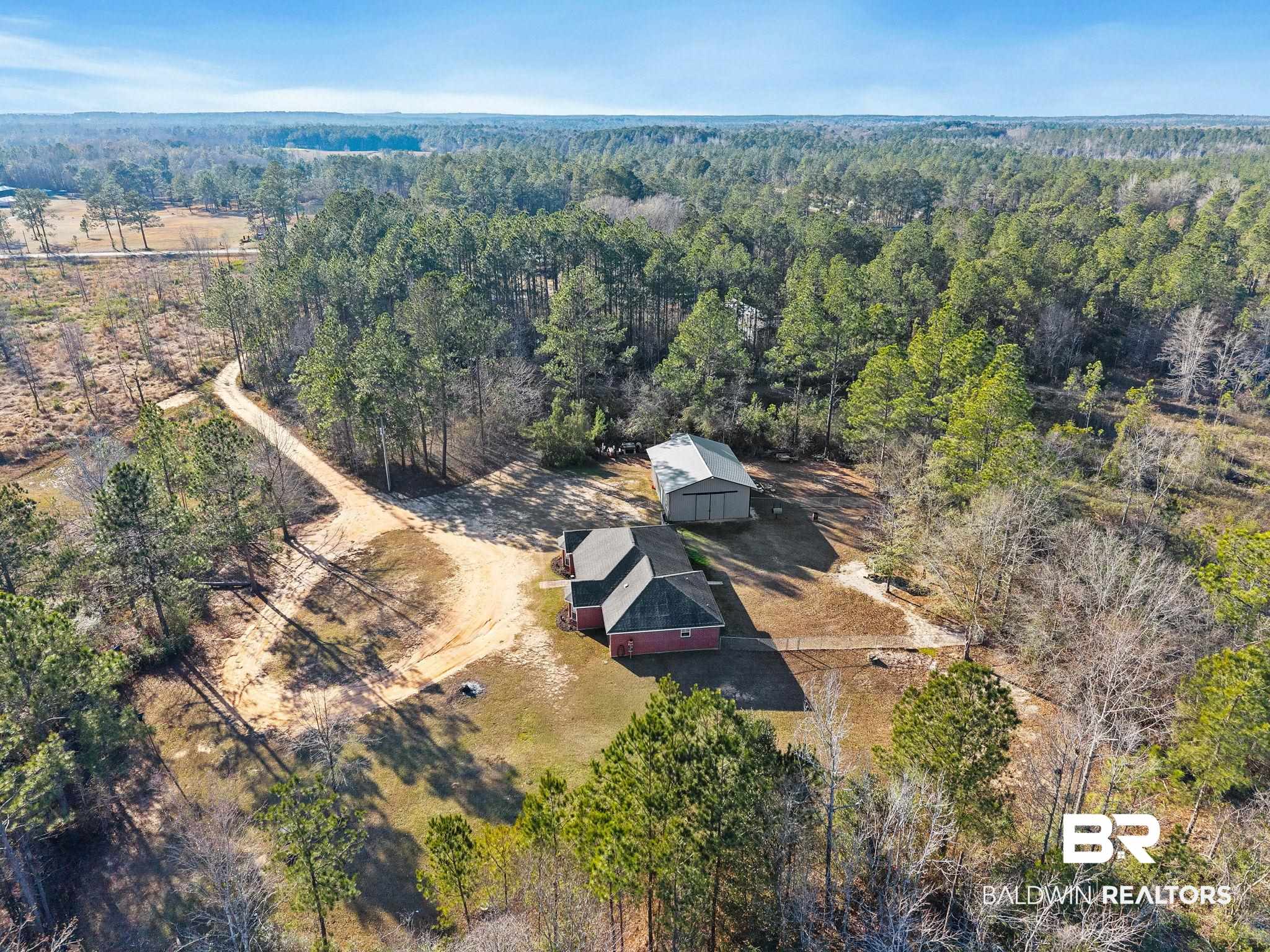 55750 Lottie Road Perdido, AL 36562 - Photo 21 of 84 Aerial view of property and surrounding area featuring a forest