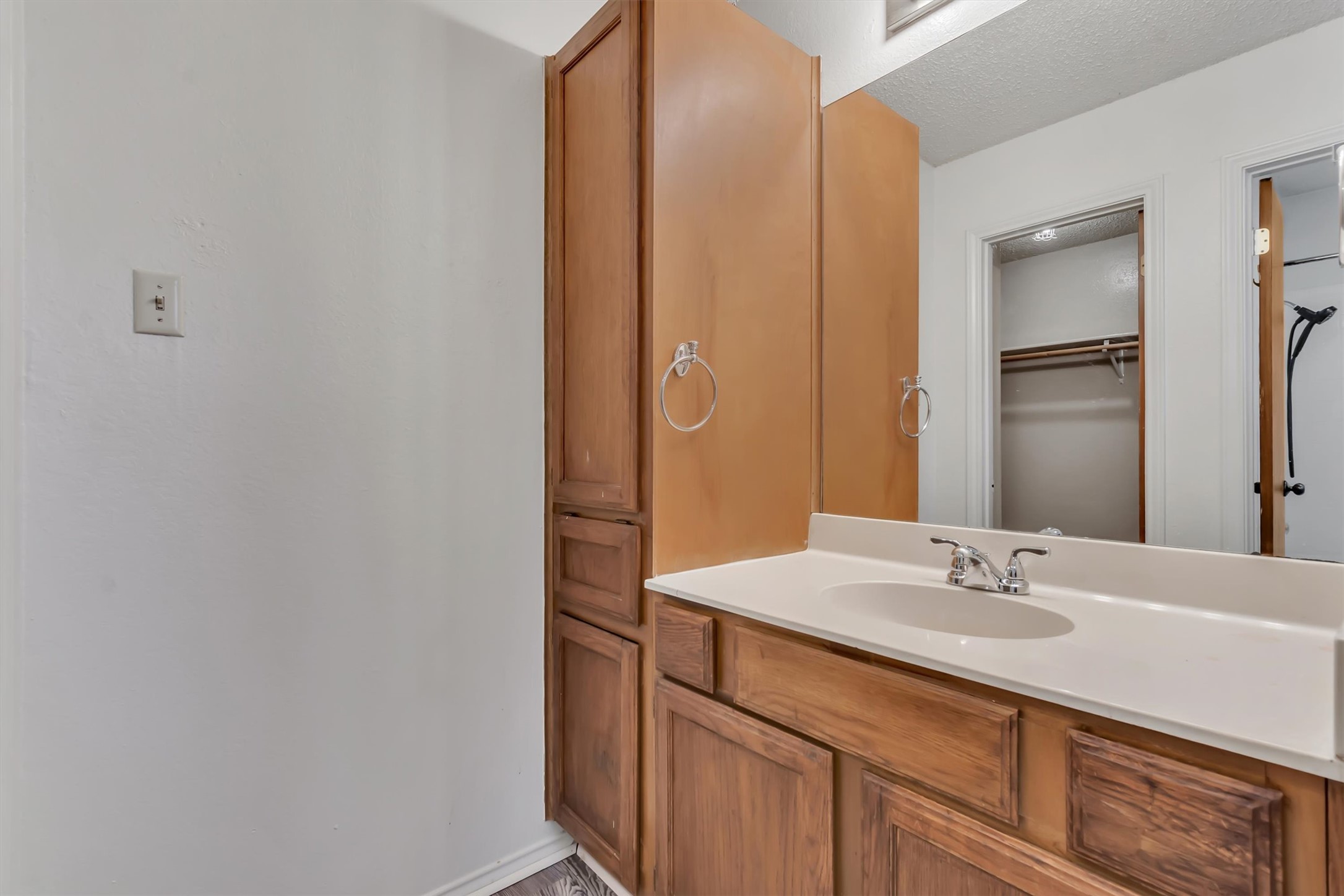 7802 Topawa Cove, Unit B Austin, TX 78729 - Photo 17 of 32 En-suite bathroom. Classic wood cabinetry provides essential storage.