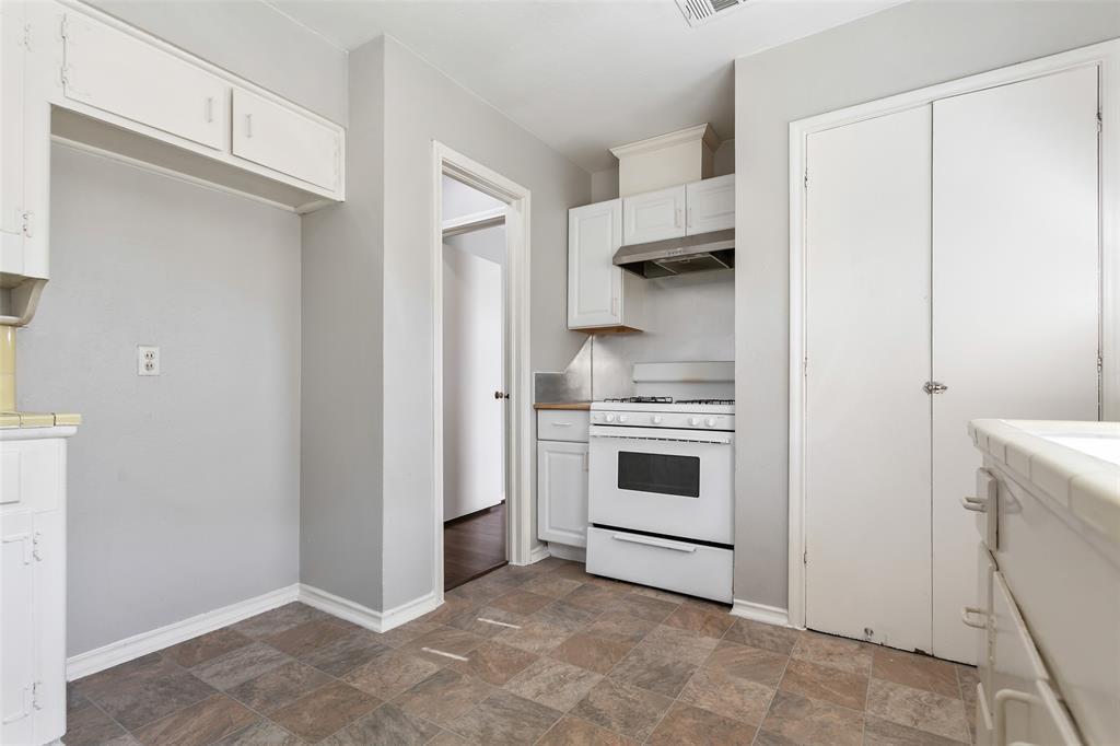 6520 St Moritz Avenue Dallas, TX 75214 - Photo 17 of 31 a kitchen with white cabinets and white appliances
