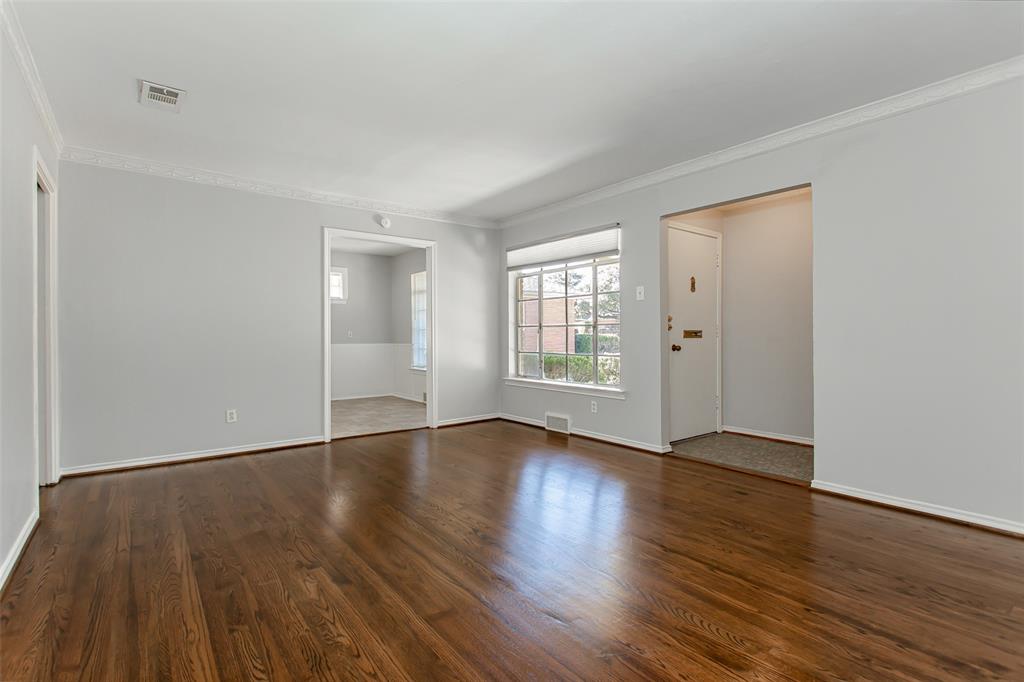 6520 St Moritz Avenue Dallas, TX 75214 - Photo 4 of 31 an empty room with wooden floor and windows