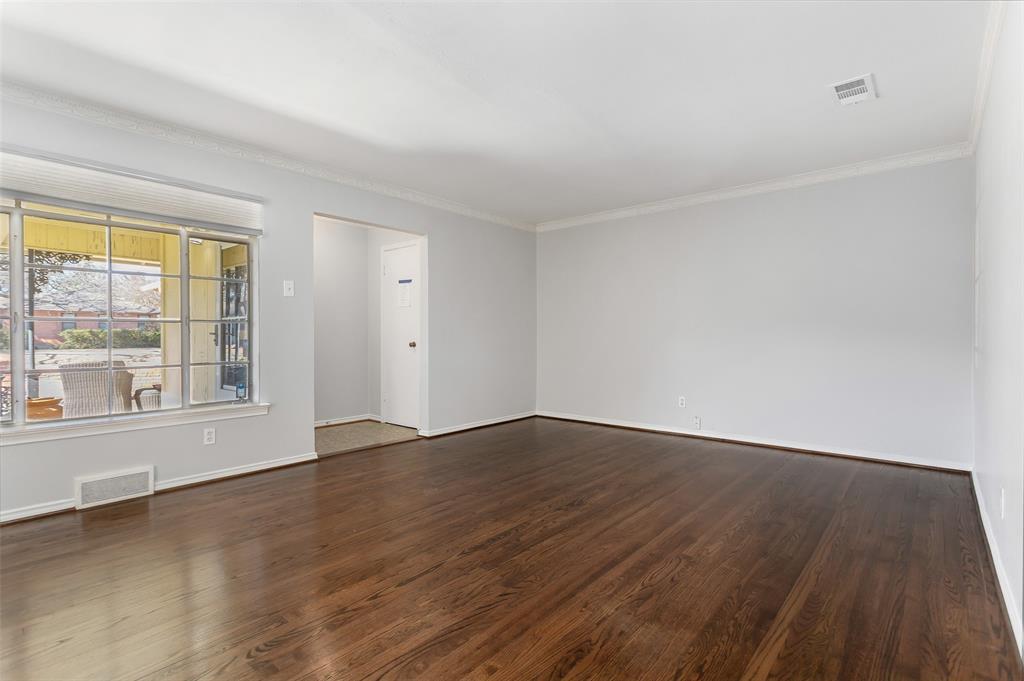 6520 St Moritz Avenue Dallas, TX 75214 - Photo 5 of 31 a view of an empty room with wooden floor and a window
