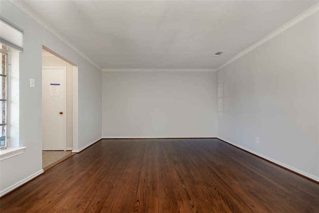 6520 St Moritz Avenue Dallas, TX 75214 - Photo 6 of 31 a view of an empty room with wooden floor and windows