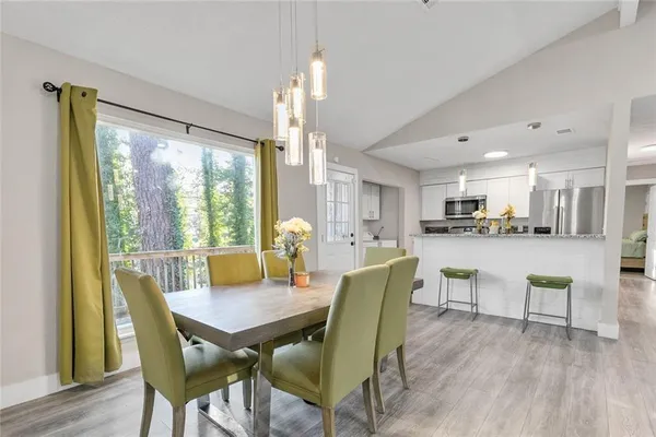 a view of a dining room with furniture and wooden floor
