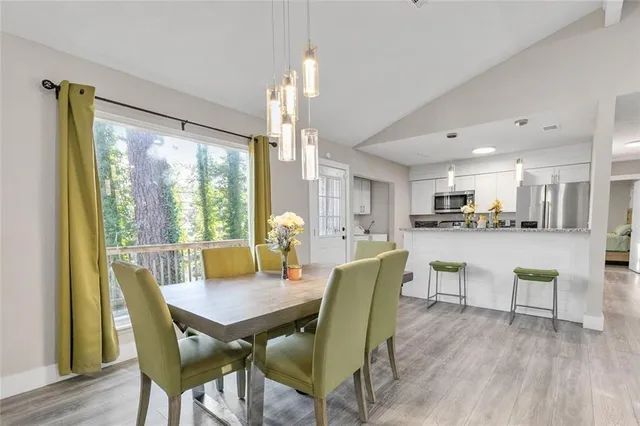 a view of a dining room with furniture and wooden floor