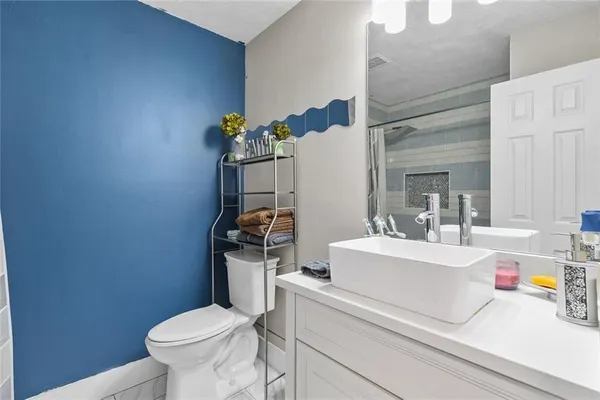 a bathroom with a sink a toilet and a mirror
