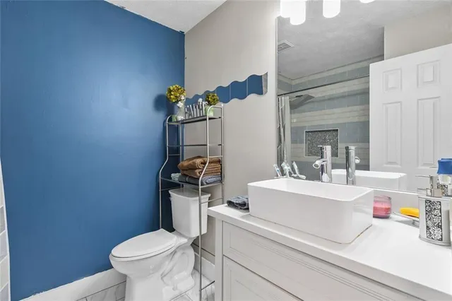 a bathroom with a sink a toilet and a mirror