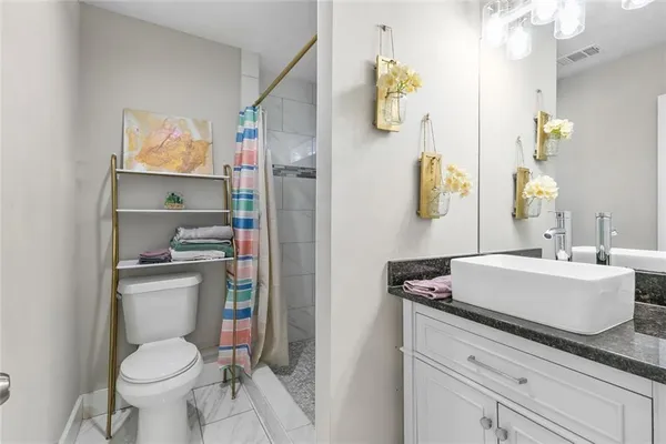 a bathroom with a sink toilet and shower