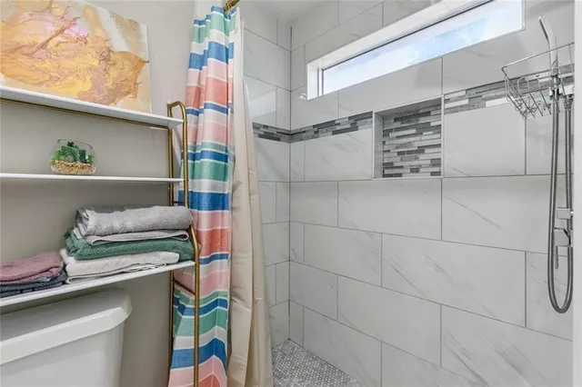 a bathroom with a walk in closet and a window