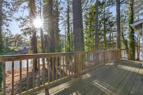 a balcony with wooden floor and fence