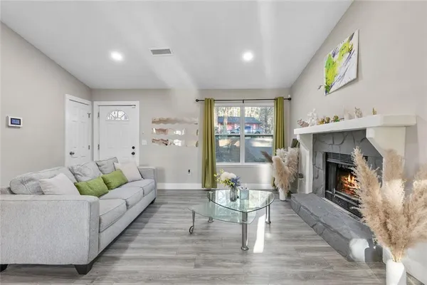 a living room with furniture and a fireplace