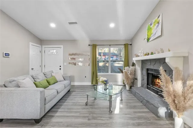 a living room with furniture and a fireplace