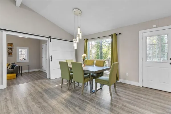 a view of a dining room with furniture and wooden floor