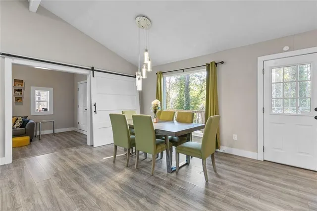 a view of a dining room with furniture and wooden floor