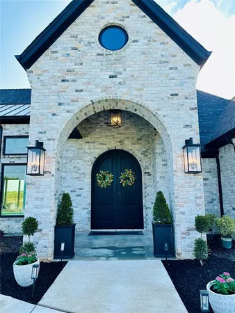 a front view of a house with garden