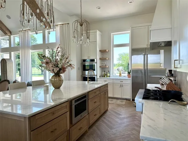 a kitchen with counter top space and living room view