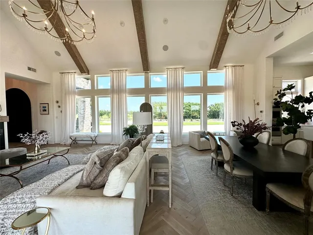 a living room with furniture large window and flat screen tv