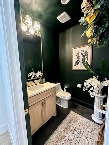 a bathroom with a sink mirror and toilet