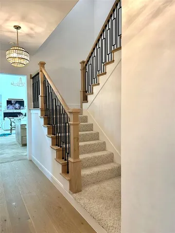 a view of staircase with lots of frames and a rug