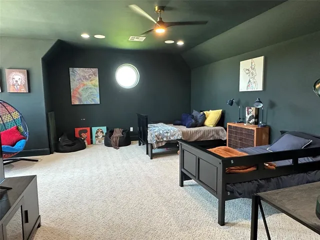 a bedroom with furniture and a potted plant