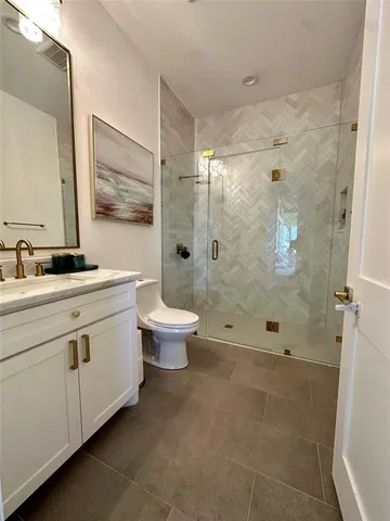 a bathroom with a double vanity sink toilet and shower