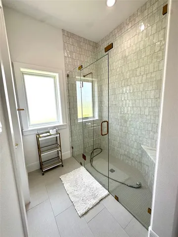 a bathroom with a shower a toilet and sink