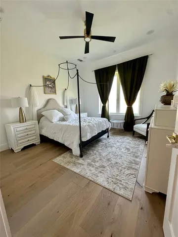 a bedroom with a bed next to a window with the outer view