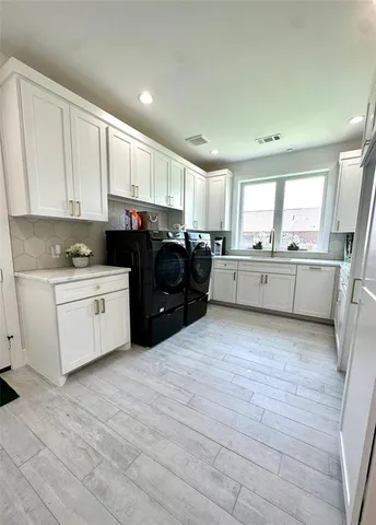a large white kitchen with cabinets and a stove