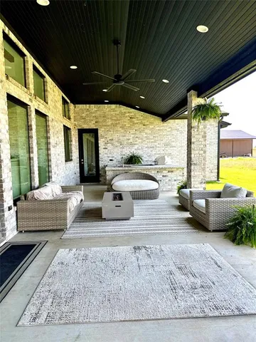 a bedroom with furniture and a large window