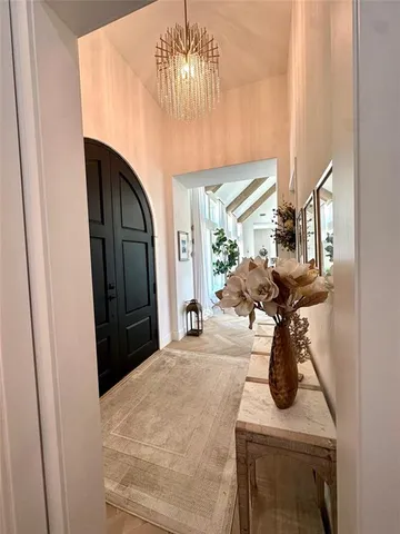 a bedroom with a bed and chandelier