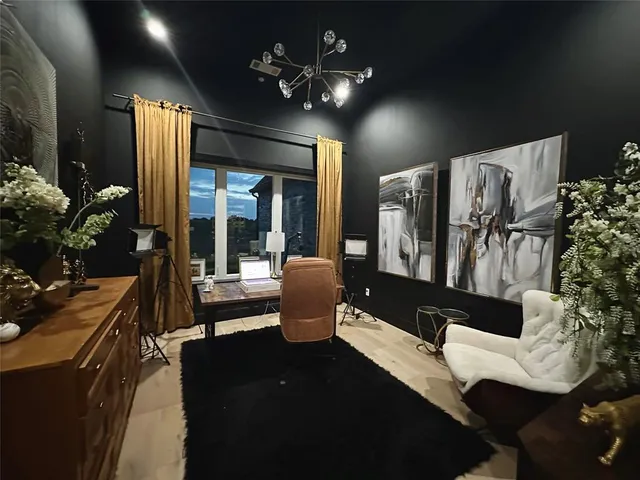 a living room with furniture fireplace and potted plants