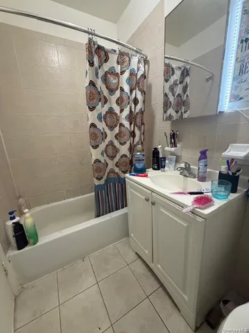 a bathroom with a sink a toilet a mirror and shower