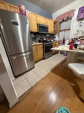 a kitchen with a refrigerator and a stove