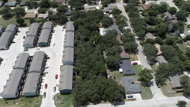an aerial view of residential houses with outdoor space