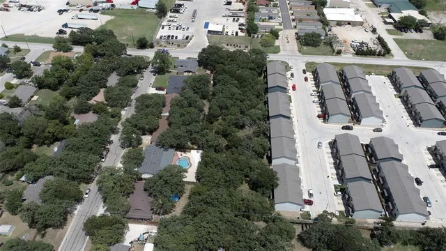 an aerial view of residential houses with outdoor space