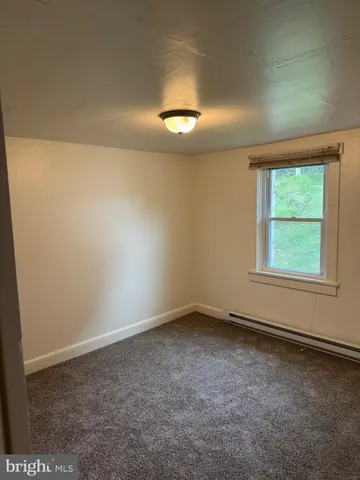 an empty room with a empty space and a window