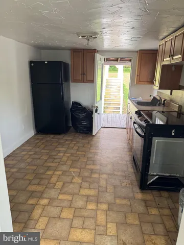 a kitchen with stainless steel appliances a stove a sink and a refrigerator