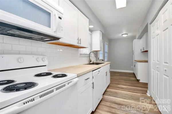 a kitchen with stainless steel appliances granite countertop a sink and cabinets