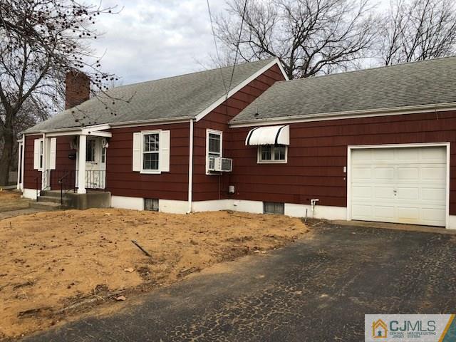 17 Clausen Road Edison, NJ 08817 - Photo 2 of 18 a front view of a house with a yard covered in snow
