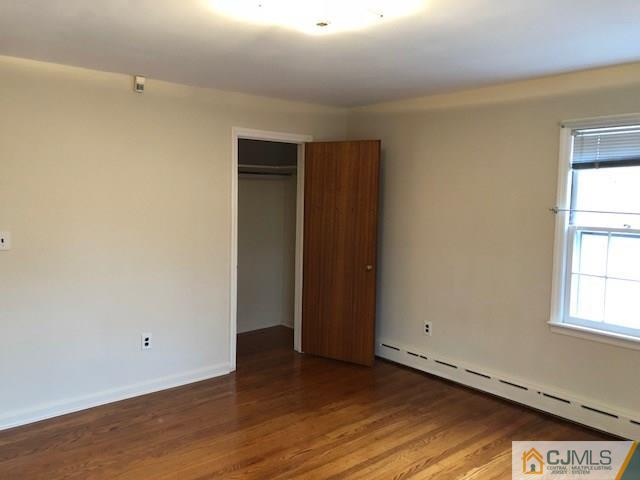 17 Clausen Road Edison, NJ 08817 - Photo 11 of 18 an empty room with wooden floor and windows