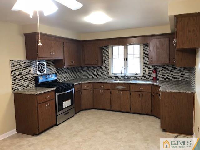 17 Clausen Road Edison, NJ 08817 - Photo 4 of 18 a kitchen with stainless steel appliances granite countertop a sink stove and cabinets