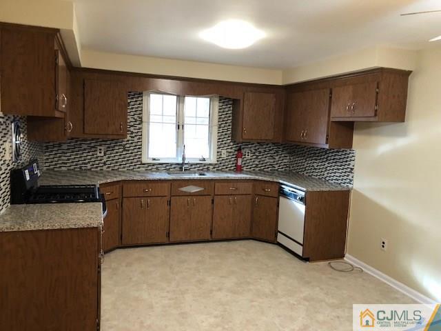 17 Clausen Road Edison, NJ 08817 - Photo 5 of 18 a kitchen with granite countertop a sink a stove and cabinets