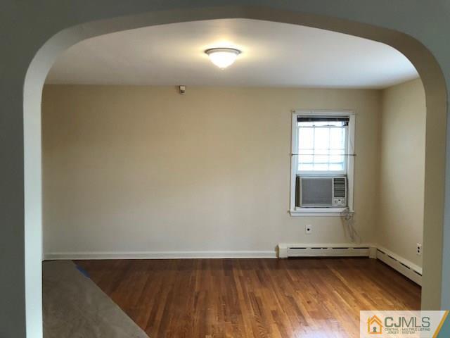 17 Clausen Road Edison, NJ 08817 - Photo 6 of 18 a view of an empty room with wooden floor and a window