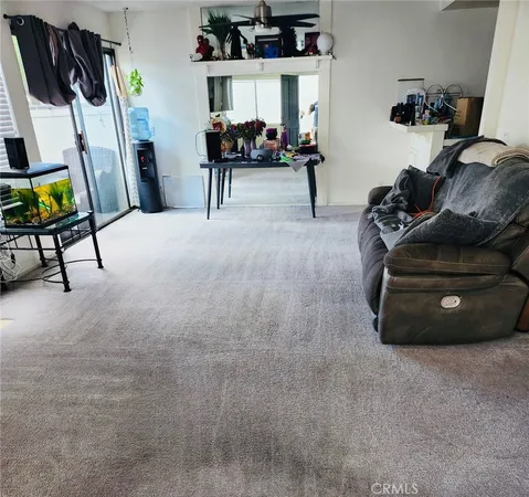 a living room with furniture and a chair