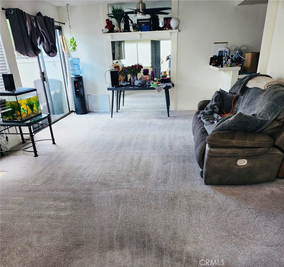 6443 Stoney View Lane, Unit 4 Simi Valley, CA 93063 - Photo 3 of 13 a living room with furniture and a chair