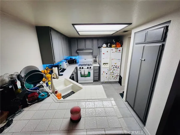a kitchen with refrigerator and washer