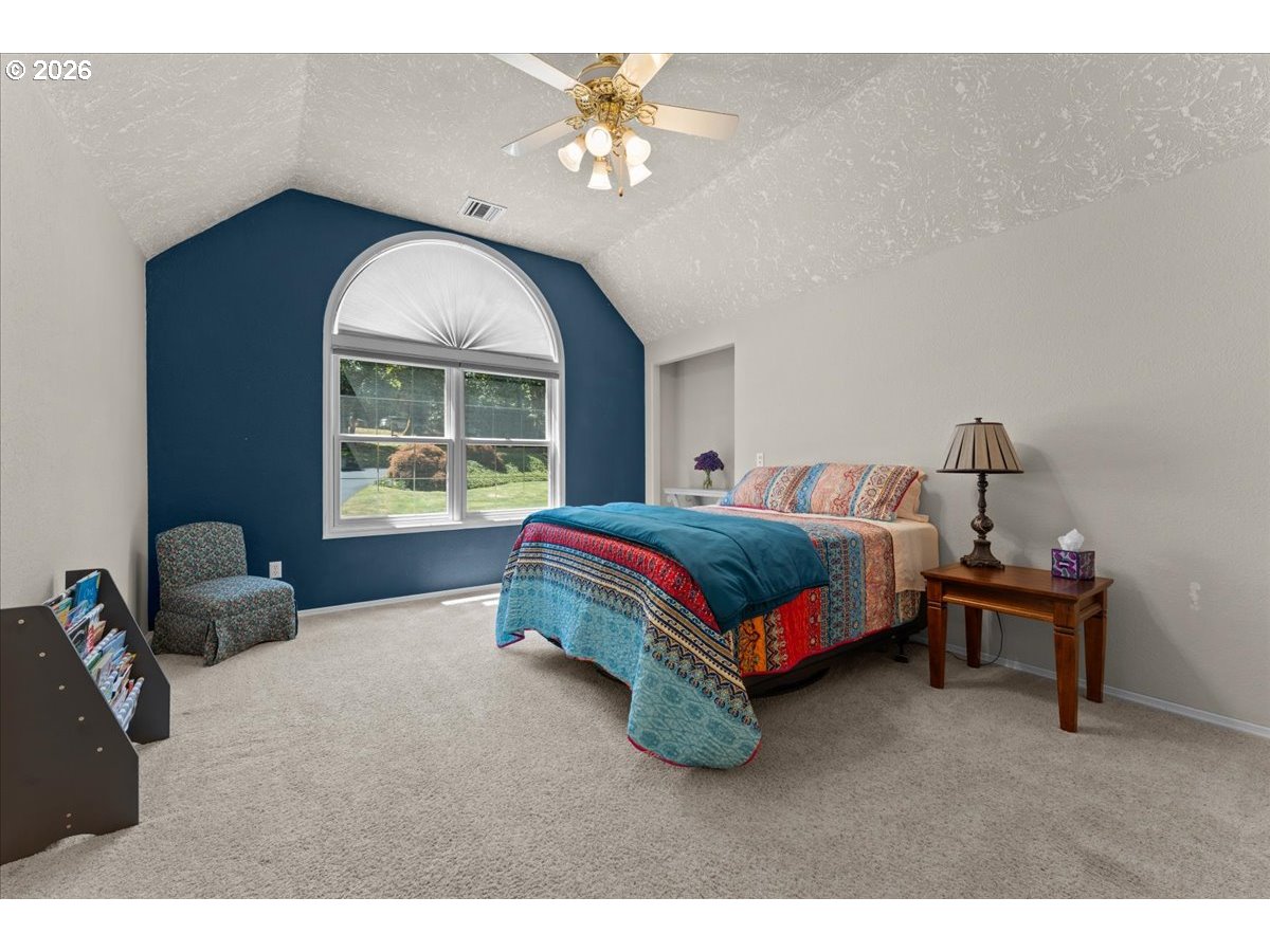 37123 Northeast Reed Road Corbett, OR 97019 - Photo 34 of 48 a bedroom with a bed and a chandelier